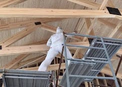 Spraying a ceiling between timber-frame beams