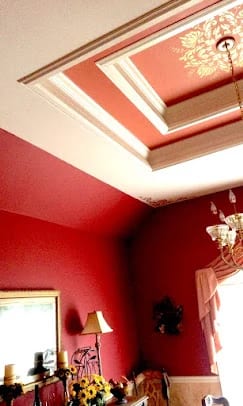 Decorative red walls and white ceiling in a finished room