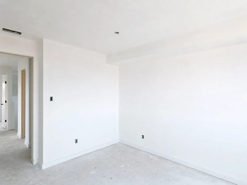 After: primed white drywall ready for paint