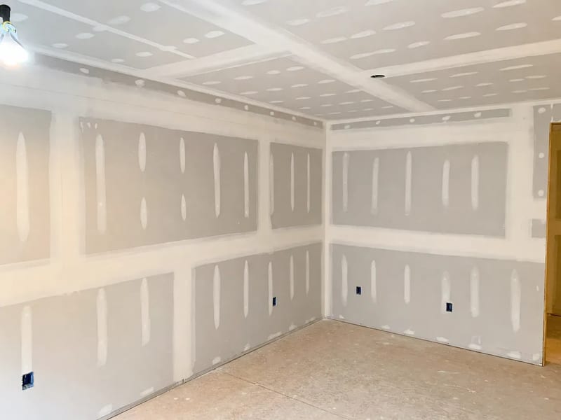Before: taped and mudded drywall before primer